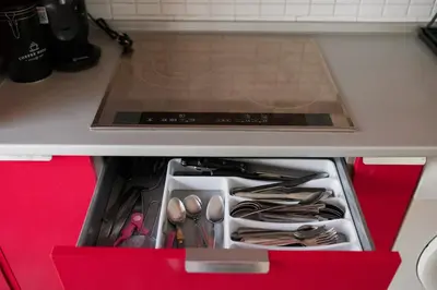 a red drawer in a kitchen with utensils at Apartamento El Catavino in Jerez de la Frontera