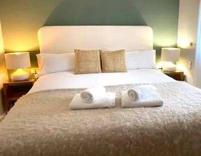a bedroom with a large bed with towels on it at Apartamento Buho Real - Vistahermosa in El Puerto de Santa María