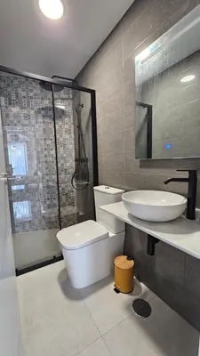 a bathroom with a toilet and a sink and a shower at Don Roman Suites en pleno centro by Sanlúcar Housing in Sanlúcar de Barrameda