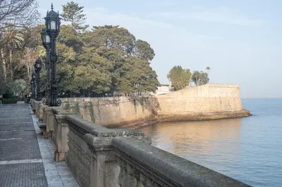 a bridge with street lights next to a body of water at Apartamento El Paseo de la Alameda de Cádiz in Cádiz