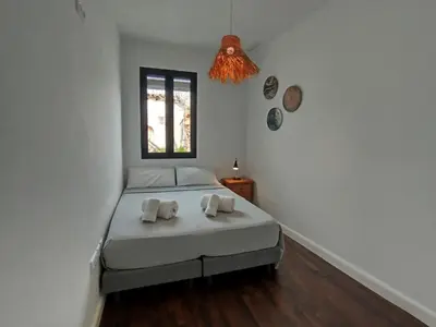 a bedroom with a bed and a window at Preciosa Casa Centro Histórico Jerez, Parking privado+ WI-FI in Jerez de la Frontera