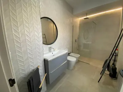 a bathroom with a sink and a toilet and a mirror at Preciosa Casa Centro Histórico Jerez, Parking privado+ WI-FI in Jerez de la Frontera