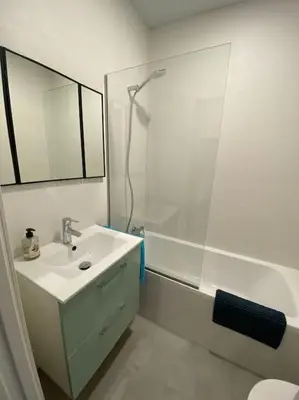 a white bathroom with a sink and a shower at Preciosa Casa Centro Histórico Jerez, Parking privado+ WI-FI in Jerez de la Frontera