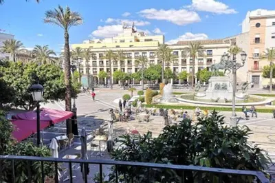 a park with a fountain and a large building at Preciosa Casa Centro Histórico Jerez, Parking privado+ WI-FI in Jerez de la Frontera