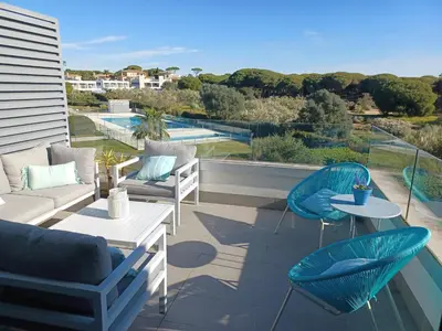 a patio with chairs and tables on a balcony at Jardines de Vistahermosa in El Puerto de Santa María