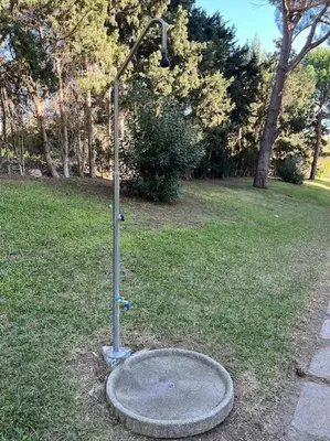 a shower in the grass in a park at Apartamento Playa El Manantial in El Puerto de Santa María