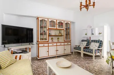 a living room with a tv and a couch and a tvicter at Tramontana in Conil de la Frontera