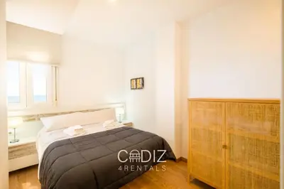 a living room with a couch and a television at ORILLITA Beach by Cadiz4Rentals in Cádiz