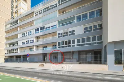 people walking on a sidewalk next to the beach at ORILLITA Beach by Cadiz4Rentals in Cádiz