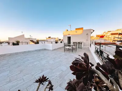 a glass table and chairs on top of a roof at Casa Mar y Montaña in Paterna de Rivera