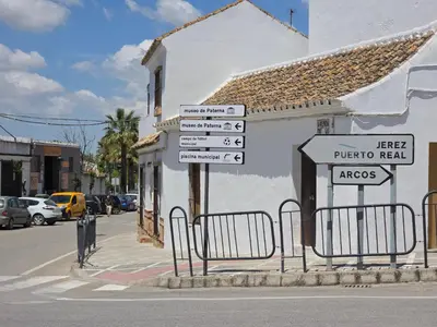 a white building with a balcony on top of it at Casa Mar y Montaña in Paterna de Rivera