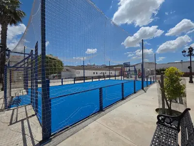 a swimming pool behind a fence with a bench at Casa Mar y Montaña in Paterna de Rivera