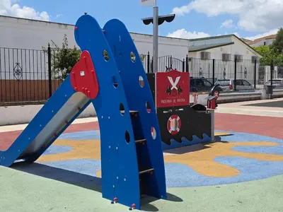 a playground with a blue slide in a park at Casa Mar y Montaña in Paterna de Rivera