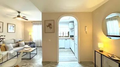 a living room with a couch and a table at Sibs Sanlucar Alcazar - Duplex Recién Reformado in Sanlúcar de Barrameda
