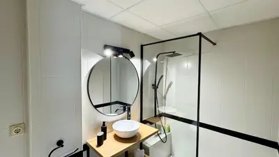 a bathroom with a sink and a mirror at Sibs Sanlucar Alcazar - Duplex Recién Reformado in Sanlúcar de Barrameda