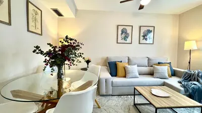 a living room with a couch and a glass table at Sibs Sanlucar Alcazar - Duplex Recién Reformado in Sanlúcar de Barrameda