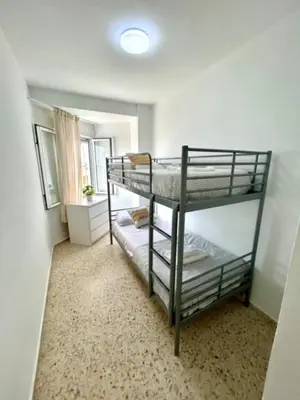a bedroom with two bunk beds in a room at GATU VALDEPLAYA 1ª linea playa piscina parking 3 dormit 2 baños, 