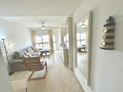 a living room with a couch and a chair at GATU VALDEPLAYA 1ª linea playa piscina parking 3 dormit 2 baños, 