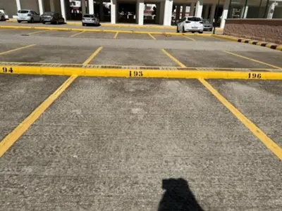 a shadow of a person standing in a parking lot at GATU DULCE junto playa, terraza, aire acc, parking, piscina , 