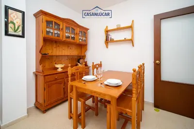 a dining room with a wooden table and chairs at Apartamento mi Gitana in La Jara