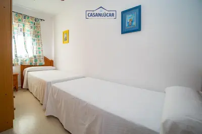 two beds in a room with a sign on the wall at Apartamento mi Gitana in La Jara