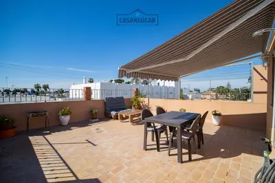 a patio with a table and chairs under a canopy at Apartamento mi Gitana in La Jara