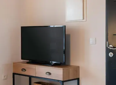 a flat screen tv sitting on top of a wooden dresser at Estudio Palacios Sur in El Puerto de Santa María