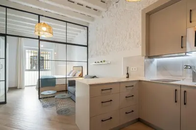a kitchen and living room with a large window at Estudio Palacios Norte in El Puerto de Santa María