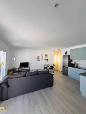 a living room with a couch and a kitchen at Casa Robin in Conil de la Frontera