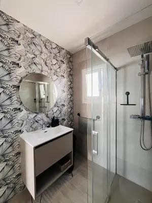a bathroom with a sink and a mirror at Casa Robin in Conil de la Frontera
