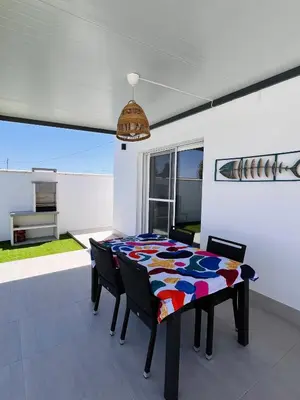 a dining room table with a colorful quilt on it at Casa Robin in Conil de la Frontera
