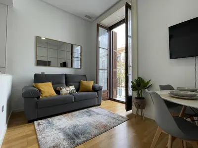 a living room with a couch and a table at Apartamento Centrico Jerez de la Frontera in Jerez de la Frontera