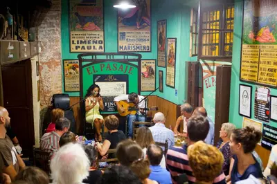 a crowd of people sitting in a room with a man playing guitar at Apartamento Centrico Jerez de la Frontera in Jerez de la Frontera