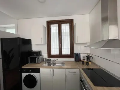 a kitchen with a sink and a black refrigerator at Apartamento Centrico Jerez de la Frontera in Jerez de la Frontera