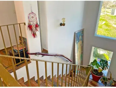 a living room with a staircase and a window at Villa Nostra in Puerto Real