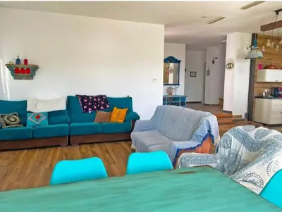 a living room with a blue couch and chairs at Villa Nostra in Puerto Real