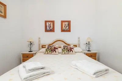 a bedroom with a bed with towels on it at Bellavista De Conil in Conil de la Frontera