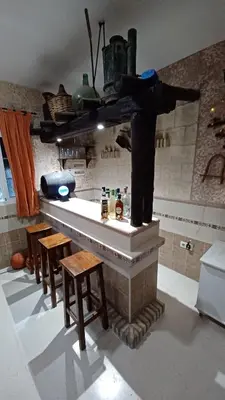 a bar in a room with some tables and chairs at Villa Mi Deseo in Sanlúcar de Barrameda