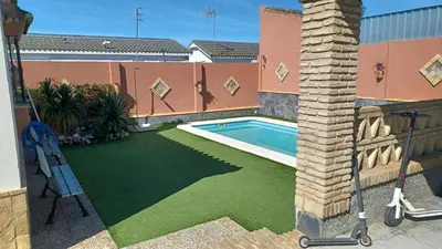 a backyard with a swimming pool and a lawn at Villa Mi Deseo in Sanlúcar de Barrameda