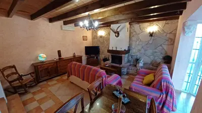 a living room with a couch and a fireplace at Villa Mi Deseo in Sanlúcar de Barrameda