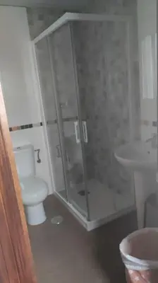 a bathroom with a shower and a toilet and a sink at Medina-Sidonia. Apartamento. Carrión y La Zaga in Medina Sidonia