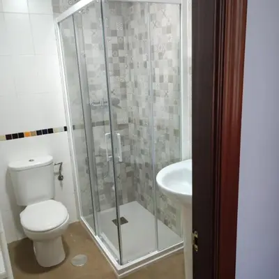 a bathroom with a shower and a toilet and a sink at Medina-Sidonia. Apartamento. Carrión y La Zaga in Medina Sidonia