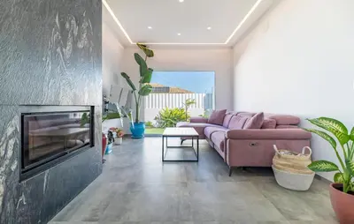 a living room with a couch and a fireplace at Gorgeous Home In Chiclana De La Fronter in Chiclana de la Frontera