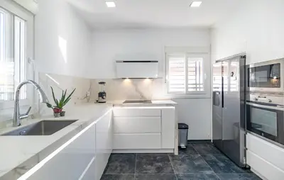a white kitchen with a sink and a refrigerator at Gorgeous Home In Chiclana De La Fronter in Chiclana de la Frontera