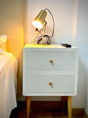a white dresser with a lamp on it next to a bed at MyChoice Salmarina in Rota