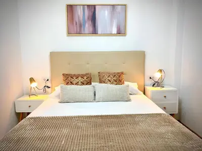 a bedroom with a large bed with two night stands at MyChoice Salmarina in Rota
