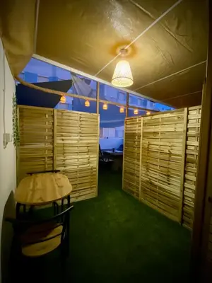 a room with a table and a room with wooden shutters at MyChoice Salmarina in Rota