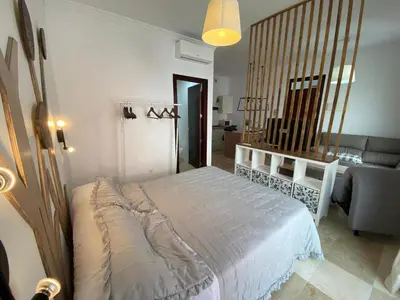 a bedroom with a bed and a living room at La Marchena in Jerez de la Frontera