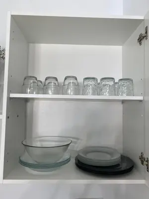 a shelf with glasses and plates in a refrigerator at La Marchena in Jerez de la Frontera