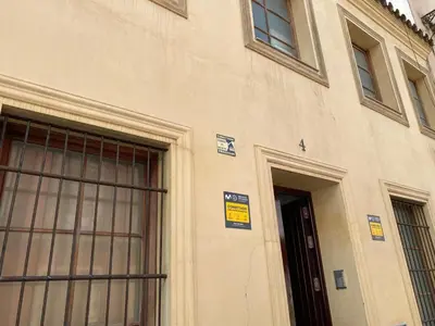 a building with two windows and a door at La Marchena in Jerez de la Frontera